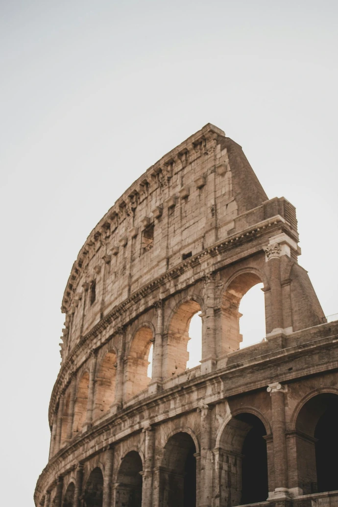 brown concrete building under white sky during daytime in Rome